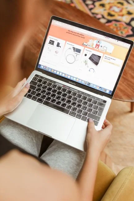 High-angle view of a stylish work desk featuring dual monitors, keyboard, mouse, and modern accessories.